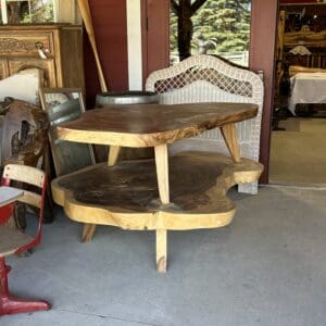 A table with two chairs and a chair in the background.