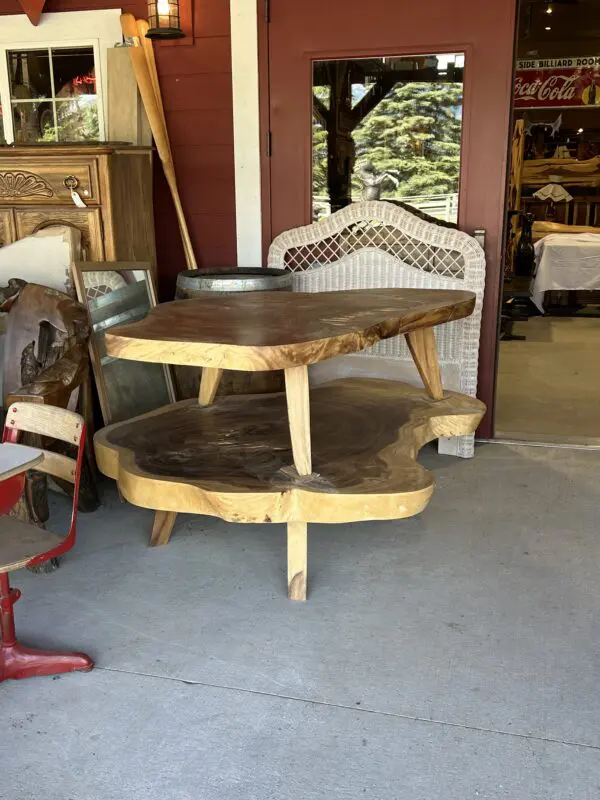 A table with two chairs and a chair in the background.