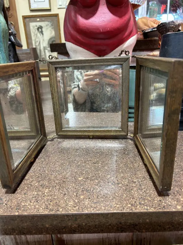 A table with three mirrors on it